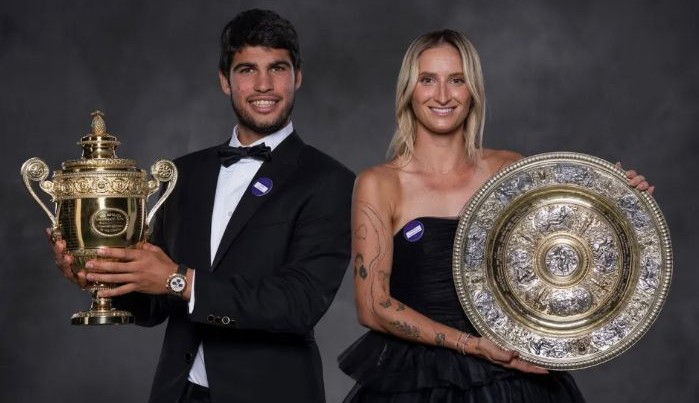 Calor Alcaraz e Marketa Vondrousova posam com seus troféus de campeões de Wimbledon