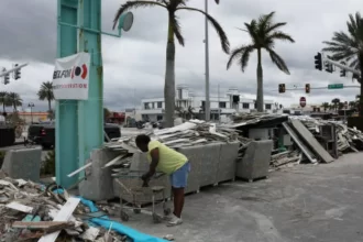 Pessoas limpando destroços