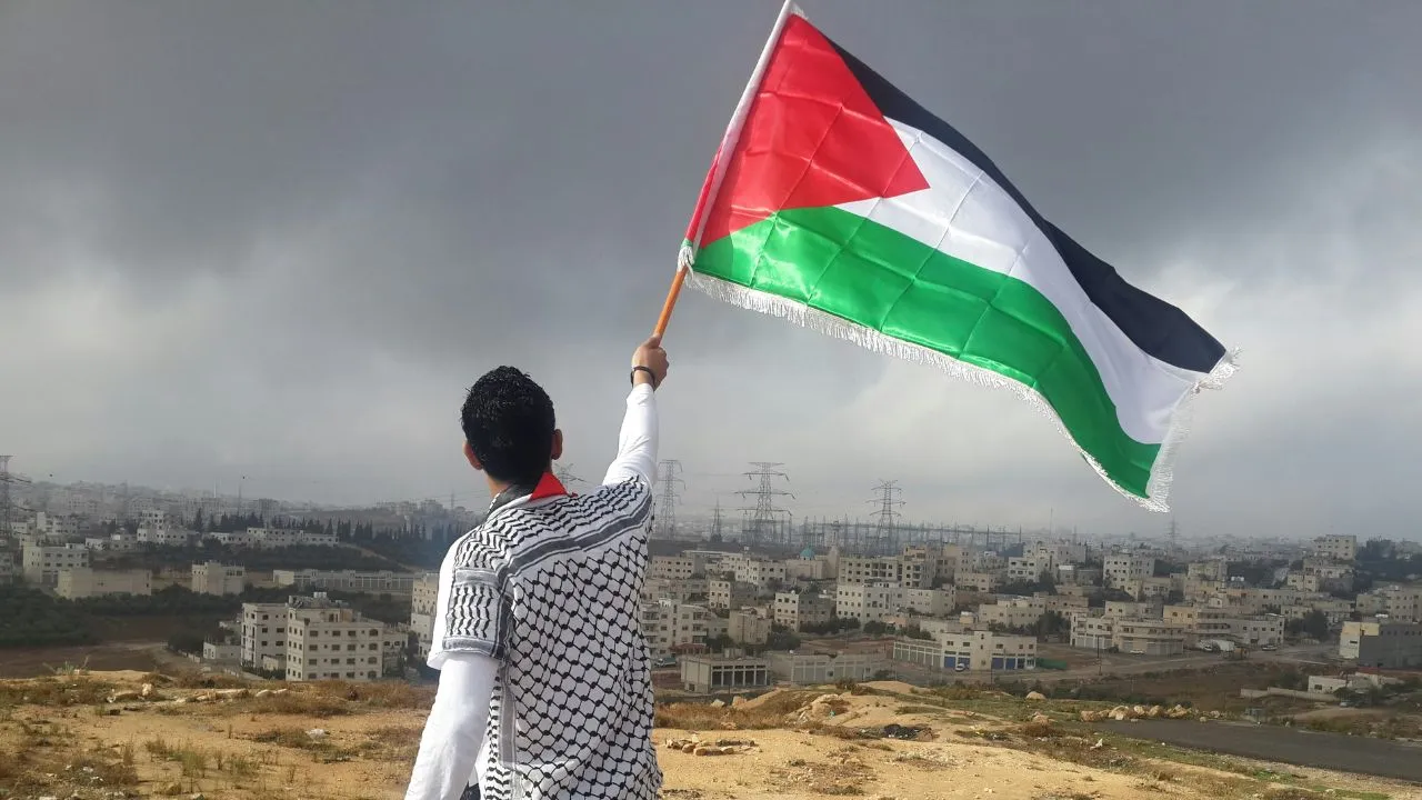 Homem segurando a bandeira da palestina