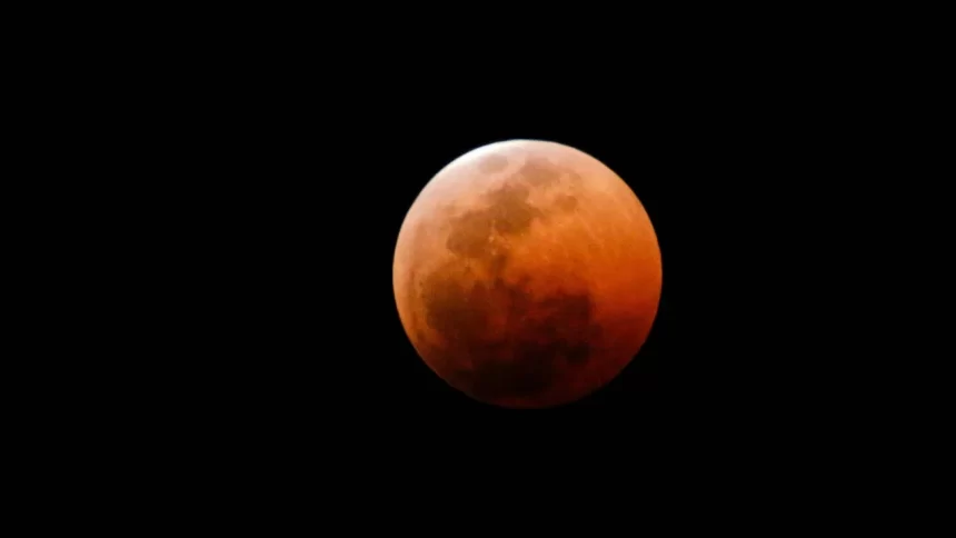 Eclipse lunar total de 2025 visto no céu com coloração avermelhada da Lua de Sangue.